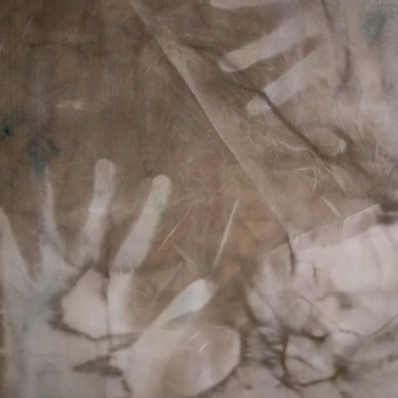 Contours of hands on fabric.